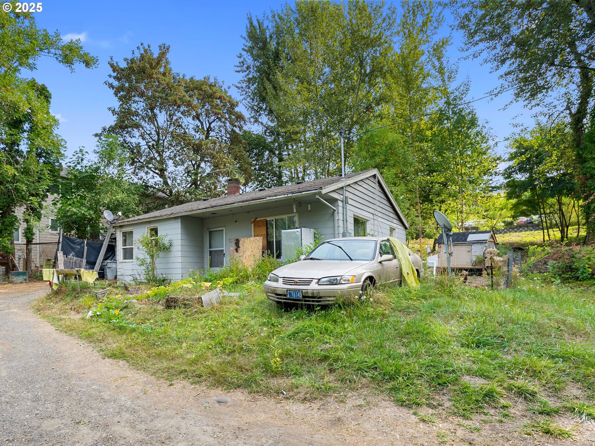 9000 Southeast Con Battin Road Happy Valley, OR 97086 - Photo 19 of 40 a backyard of a house with table and chairs