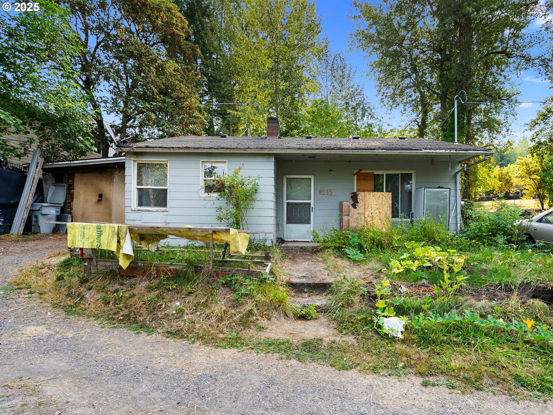 9000 Southeast Con Battin Road Happy Valley, OR 97086 - Photo 20 of 40 a backyard of a house with plants and trees