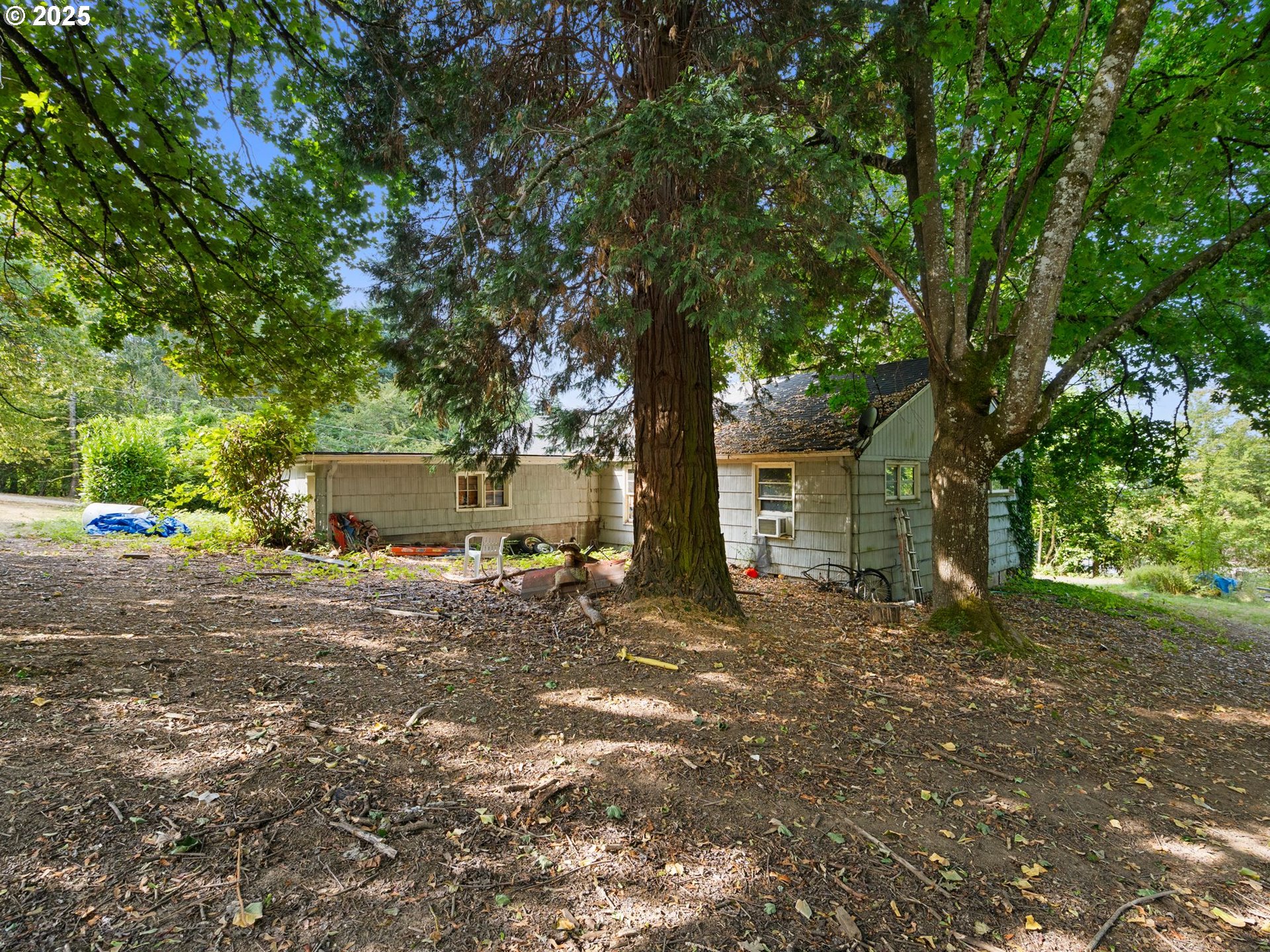 9000 Southeast Con Battin Road Happy Valley, OR 97086 - Photo 39 of 40 a view of a house with a tree in the background
