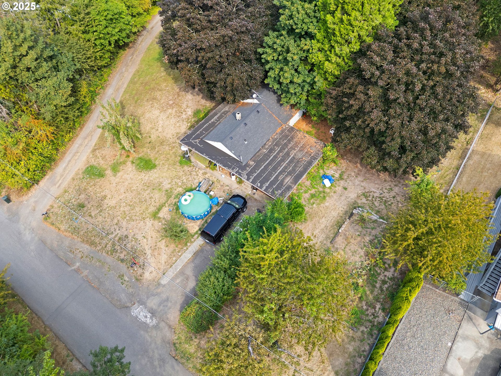 9000 Southeast Con Battin Road Happy Valley, OR 97086 - Photo 7 of 40 a aerial view of a house with a yard and garden