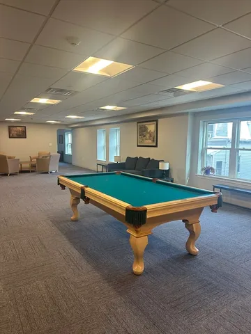 a room with pool tables and windows