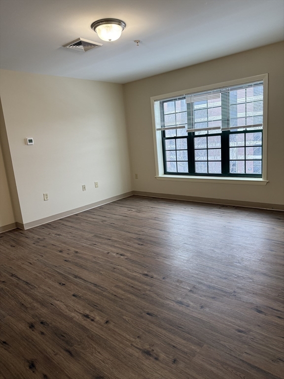 10 Florence Street, Unit 309 Malden, MA 02148 - Photo 4 of 15 wooden floor in an empty room with a window