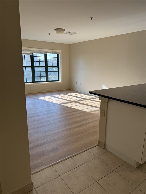 10 Florence Street, Unit 309 Malden, MA 02148 - Photo 7 of 15 wooden floor in an empty room with a window
