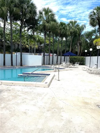 a patio with a table and chairs under an umbrella