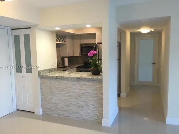 a view of living room with granite countertop couches and fireplace