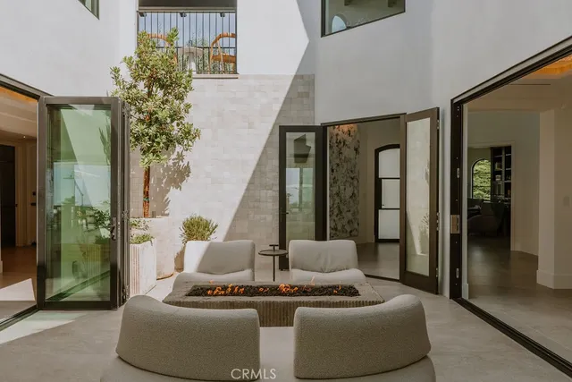 a living room with furniture and kitchen view