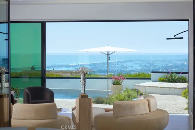 a living room with fireplace furniture and a large window