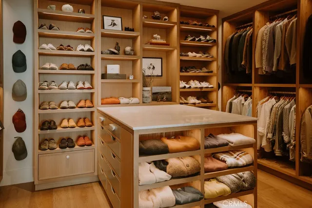 a living room with furniture a rug and kitchen view