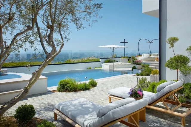a living room with couches and a floor to ceiling window