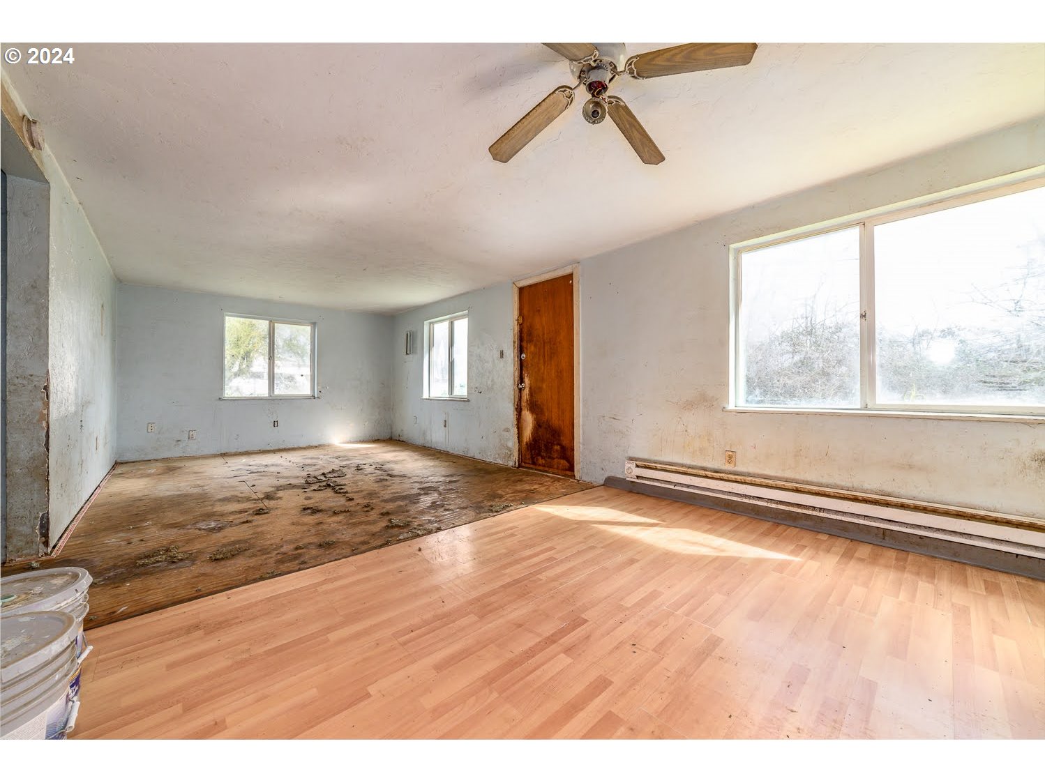 90534 Link Road Eugene, OR 97402 - Photo 3 of 19 a view of empty room with wooden floor and fan