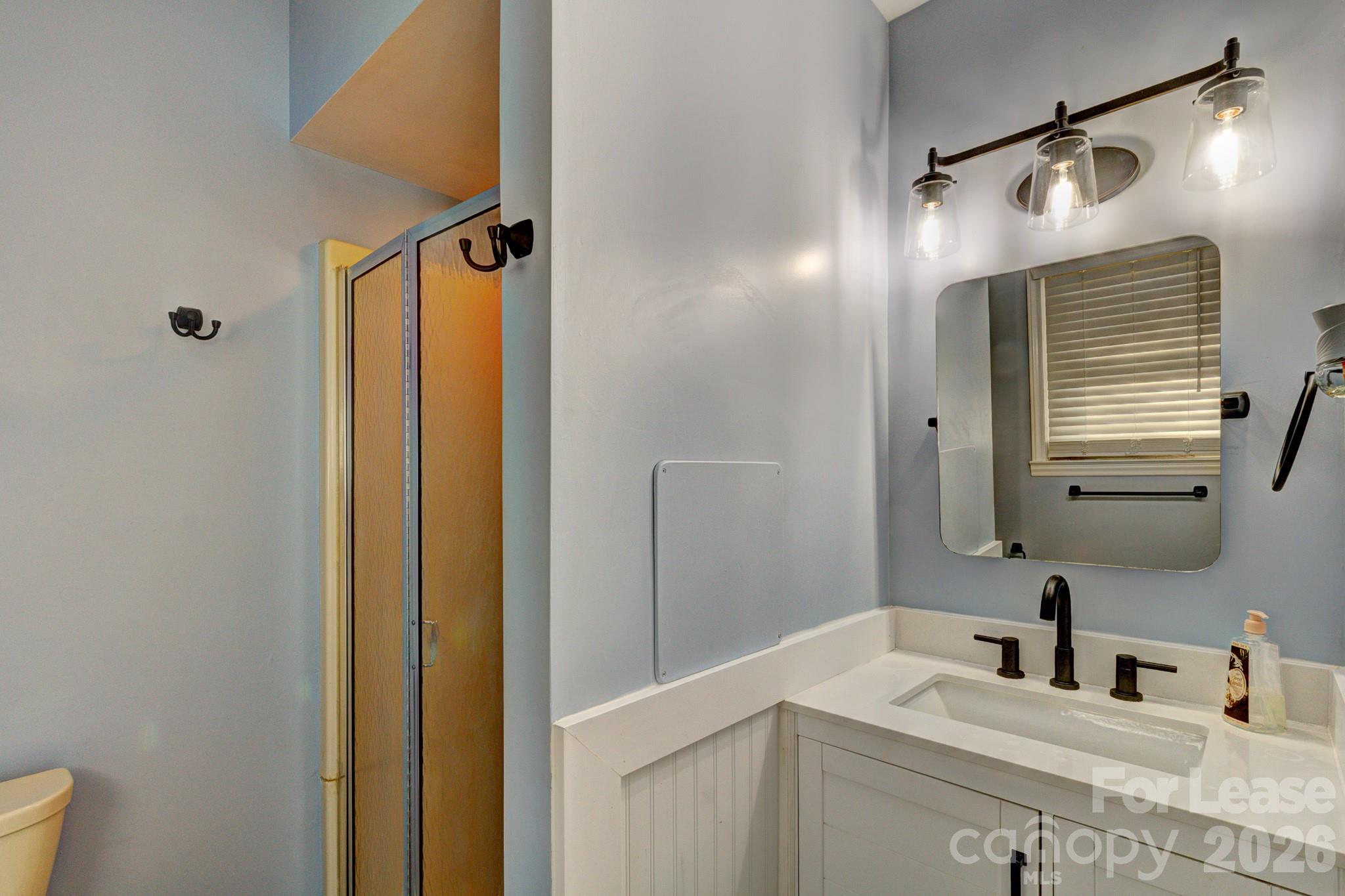 1409 Delview Road Cherryville, NC 28021 - Photo 13 of 19 a bathroom with a sink and a mirror