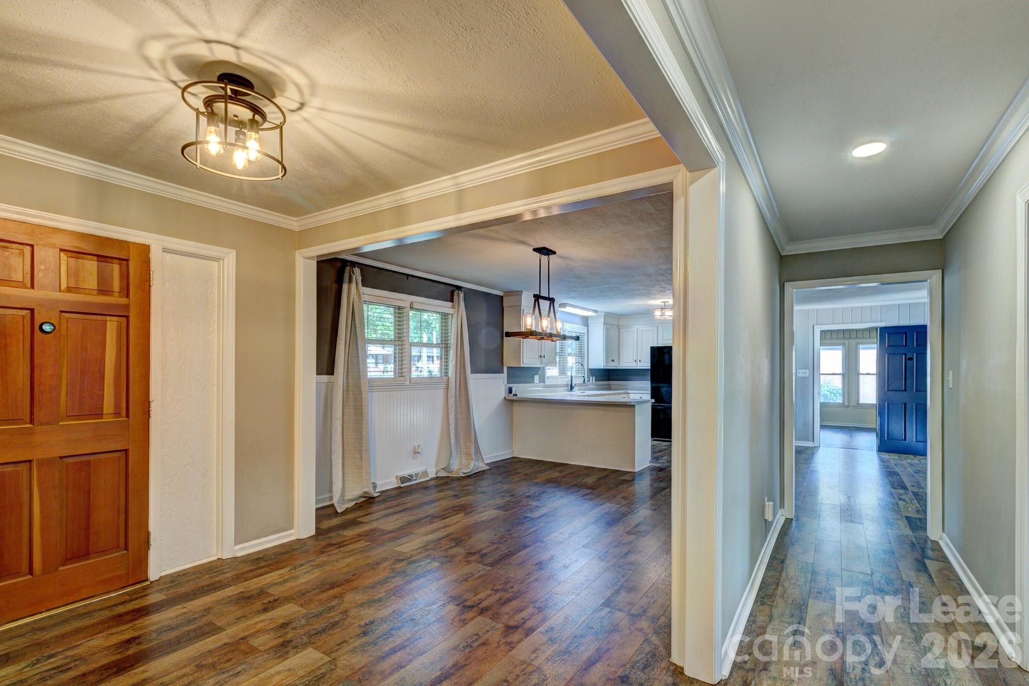 1409 Delview Road Cherryville, NC 28021 - Photo 14 of 19 a view of a hallway with wooden floor and a kitchen view