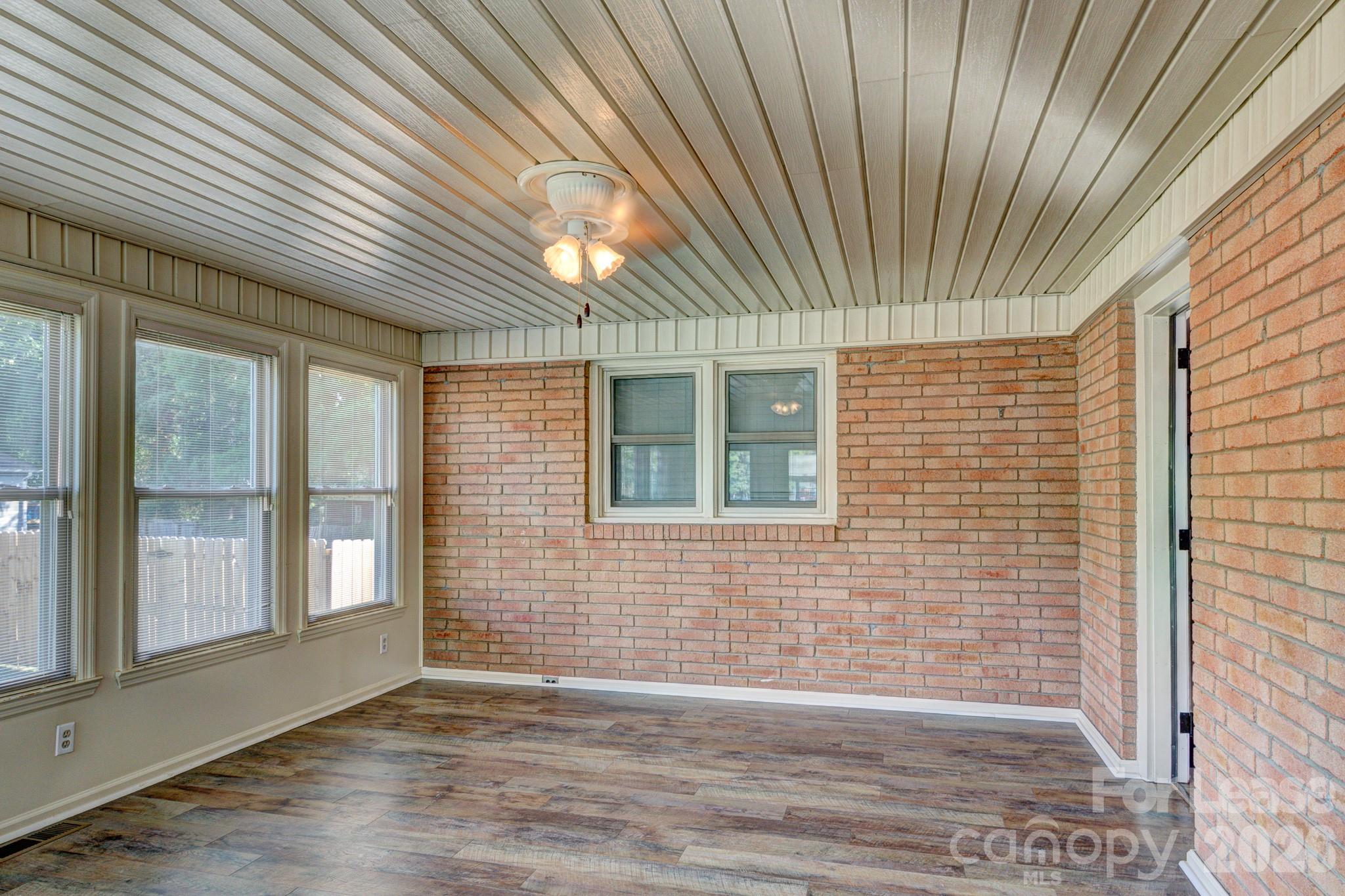 1409 Delview Road Cherryville, NC 28021 - Photo 3 of 19 a view of an empty room with wooden floor and a window