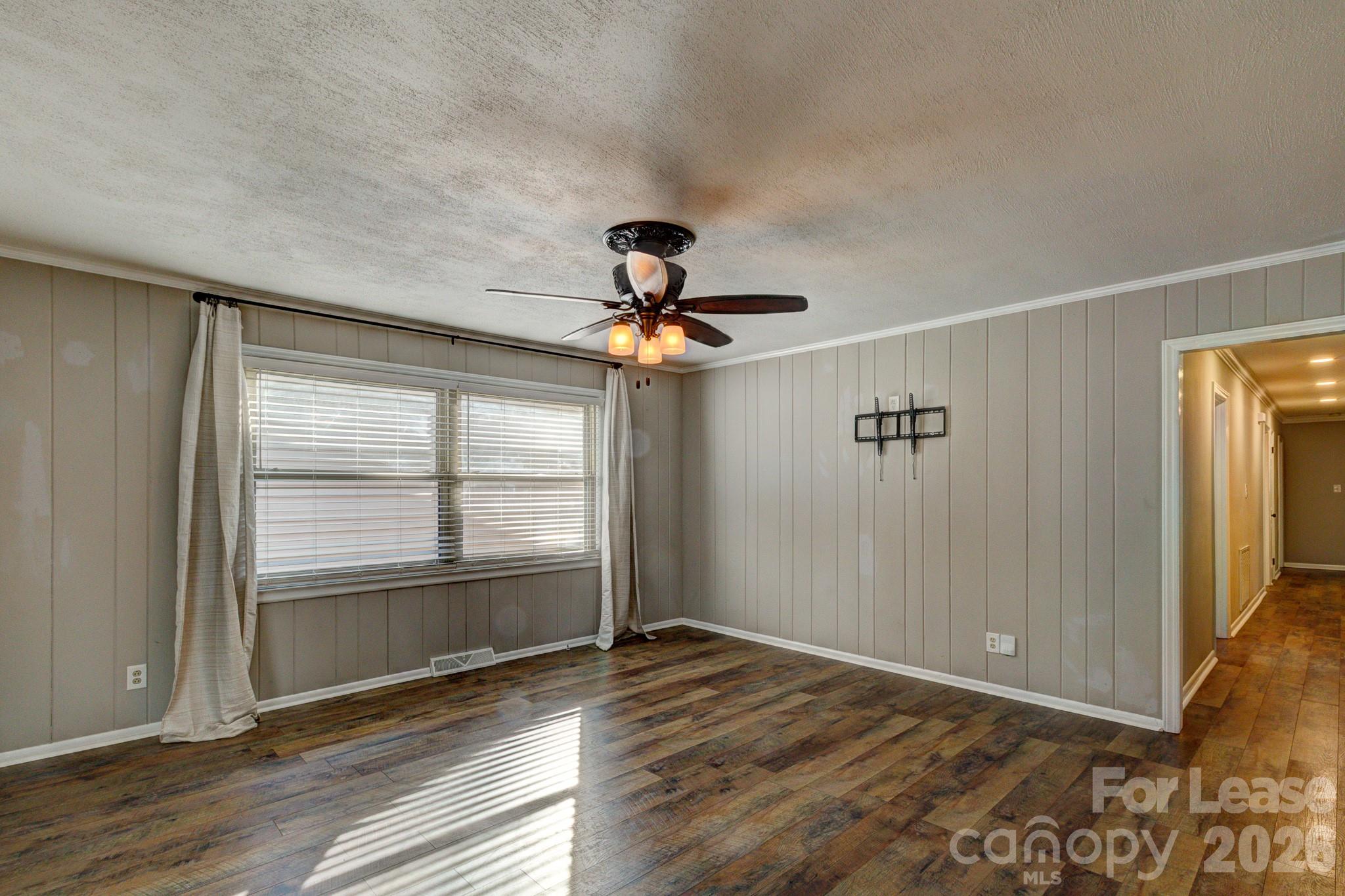 1409 Delview Road Cherryville, NC 28021 - Photo 4 of 19 a view of empty room with wooden floor and fan