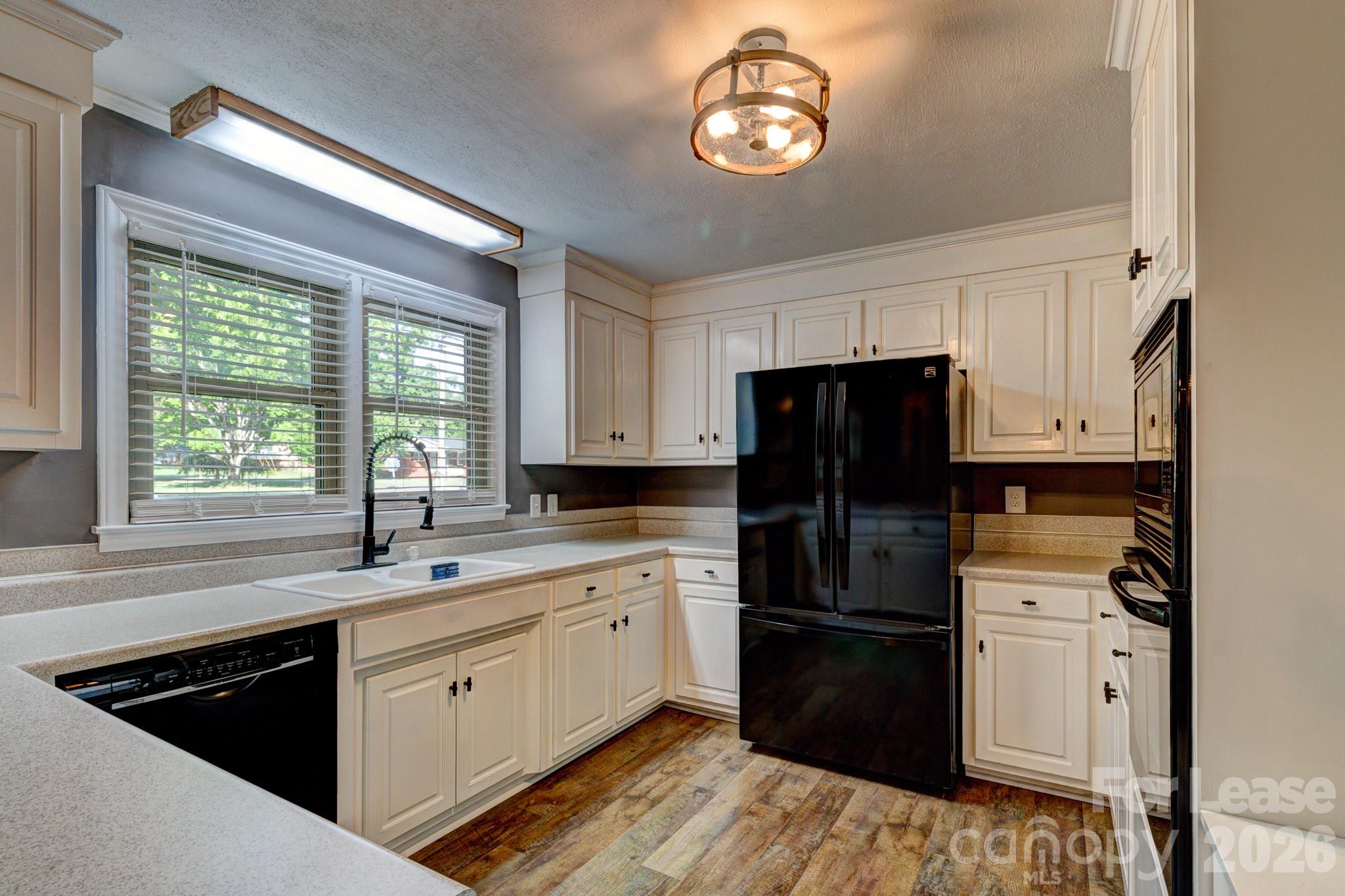 1409 Delview Road Cherryville, NC 28021 - Photo 7 of 19 a kitchen with a refrigerator and a sink