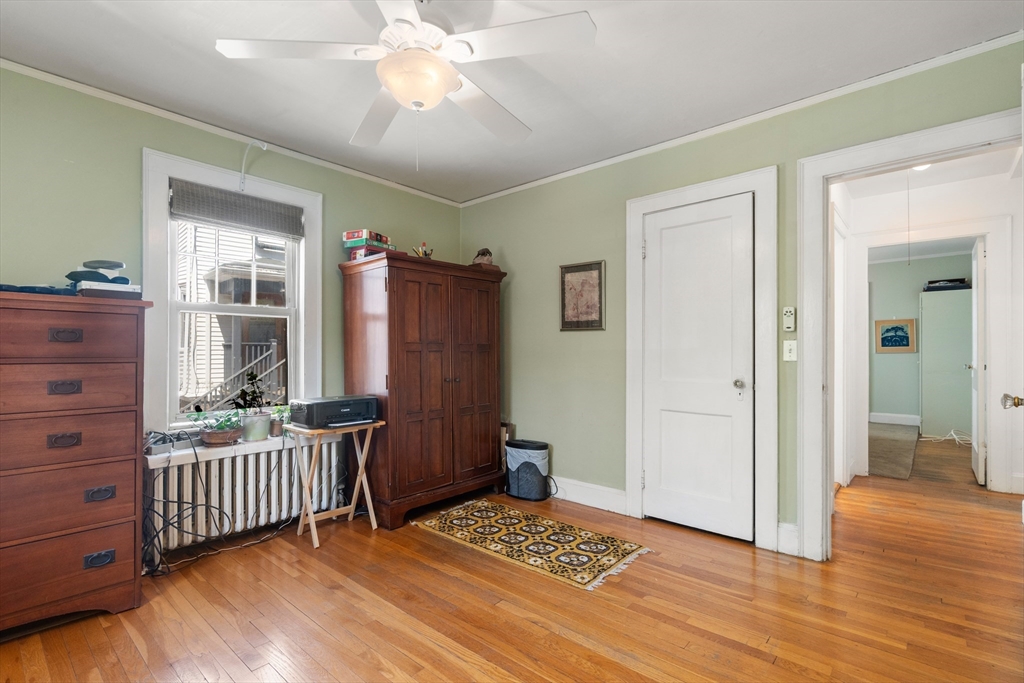 9 Searle Avenue Brookline, MA 02445 - Photo 11 of 35 a view of an empty room with a window and wooden floor