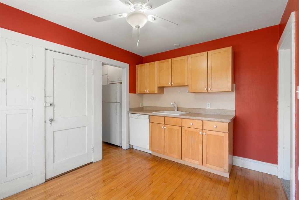 9 Searle Avenue Brookline, MA 02445 - Photo 14 of 35 a kitchen with stainless steel appliances granite countertop a refrigerator and a sink