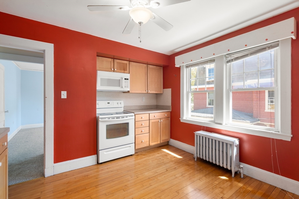 9 Searle Avenue Brookline, MA 02445 - Photo 15 of 35 a kitchen with stainless steel appliances granite countertop a stove a sink and a refrigerator