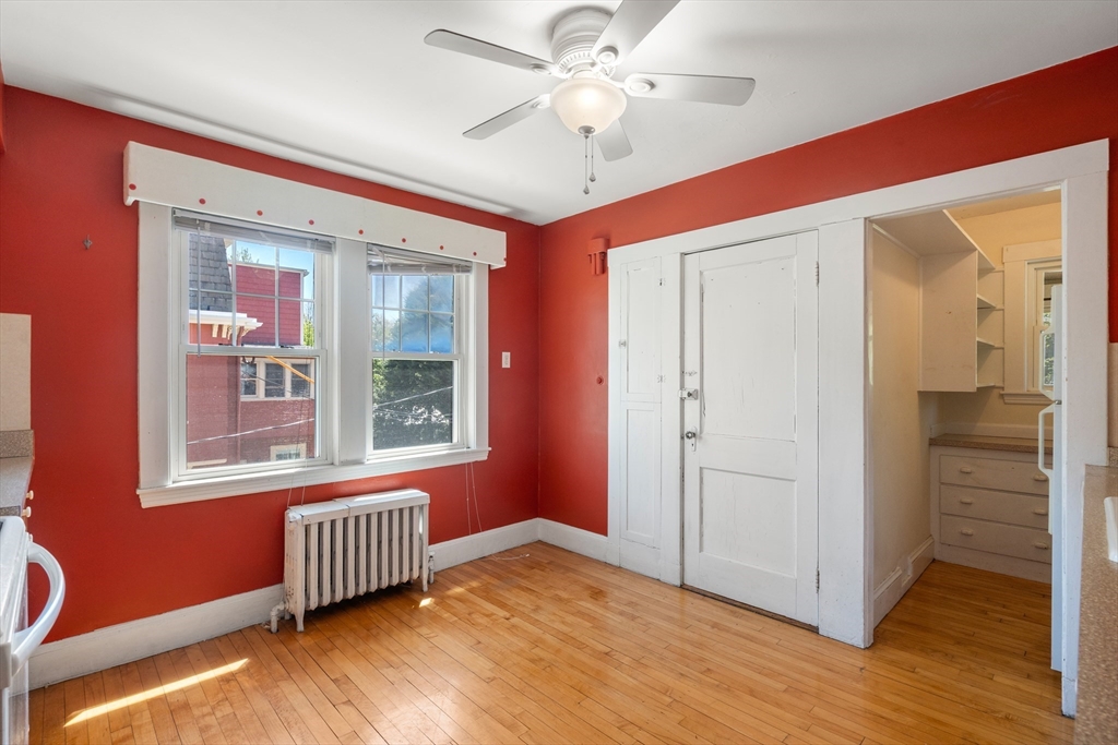 9 Searle Avenue Brookline, MA 02445 - Photo 17 of 35 a view of an empty room with window and wooden floor