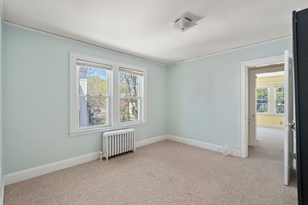 9 Searle Avenue Brookline, MA 02445 - Photo 21 of 35 an empty room with windows and closet