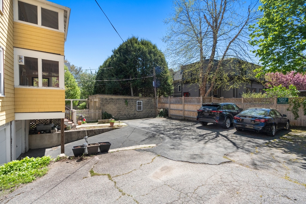 9 Searle Avenue Brookline, MA 02445 - Photo 30 of 35 a view of a backyard with a car parked in it