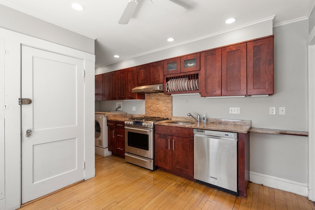 9 Searle Avenue Brookline, MA 02445 - Photo 5 of 35 a kitchen with stainless steel appliances granite countertop a stove a sink and a refrigerator
