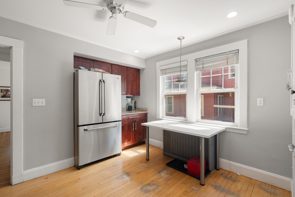 9 Searle Avenue Brookline, MA 02445 - Photo 7 of 35 a kitchen with stainless steel appliances a refrigerator and a chandelier