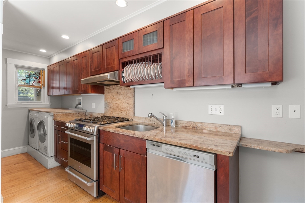 9 Searle Avenue Brookline, MA 02445 - Photo 8 of 35 a kitchen with stainless steel appliances granite countertop a stove a sink and a microwave