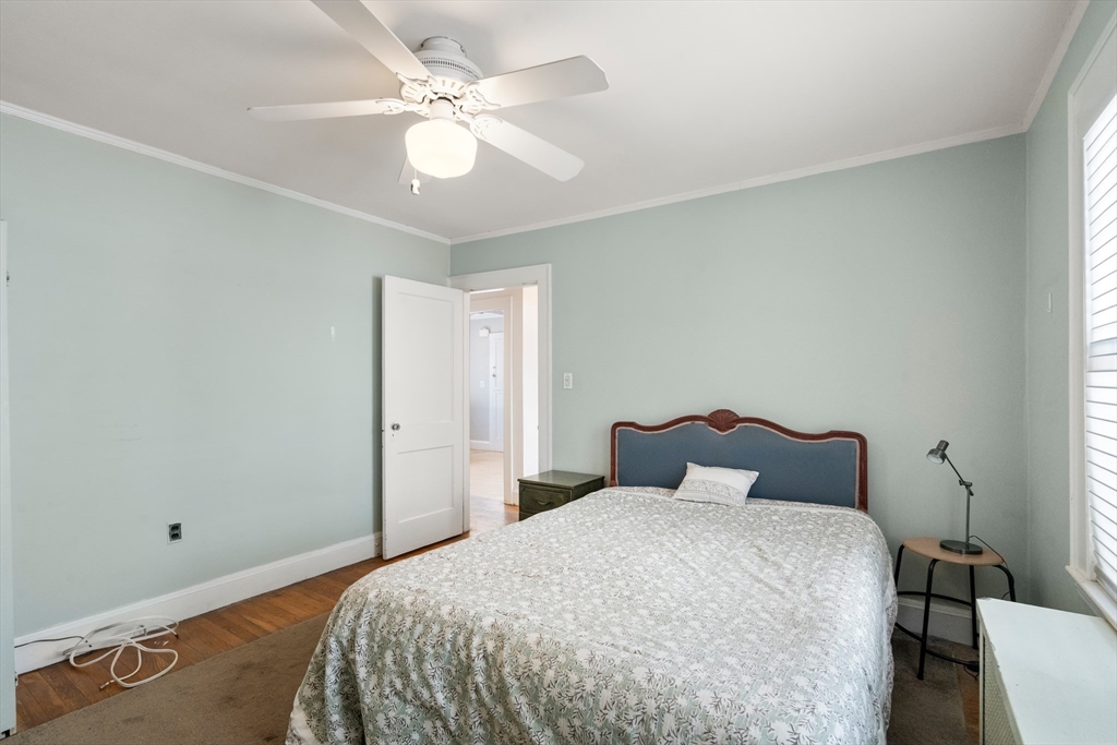 9 Searle Avenue Brookline, MA 02445 - Photo 9 of 35 a bedroom with a bed and a chandelier