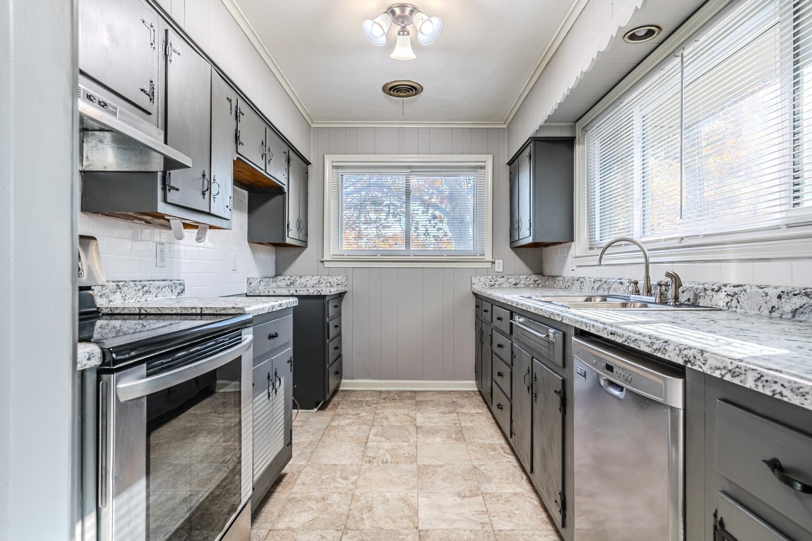 4202 Ambrose Road Memphis, TN 38116 - Photo 13 of 28 a kitchen with stainless steel appliances granite countertop a stove sink and cabinets