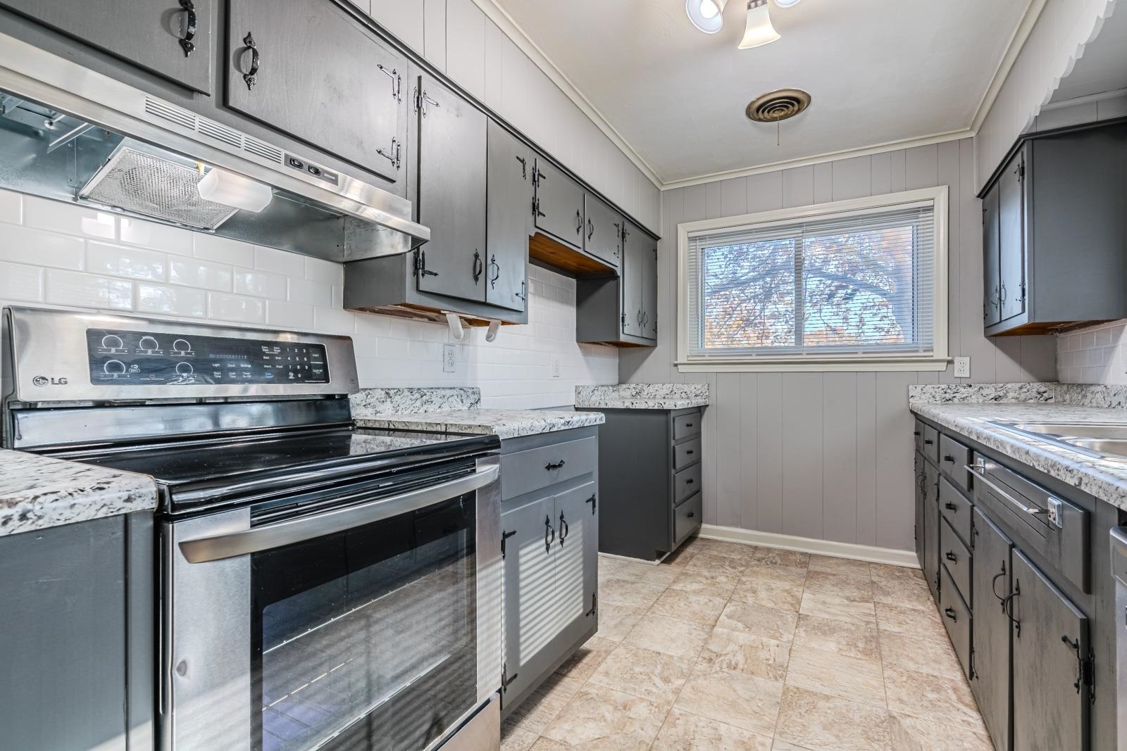 4202 Ambrose Road Memphis, TN 38116 - Photo 15 of 28 a kitchen with stainless steel appliances a stove sink and cabinets