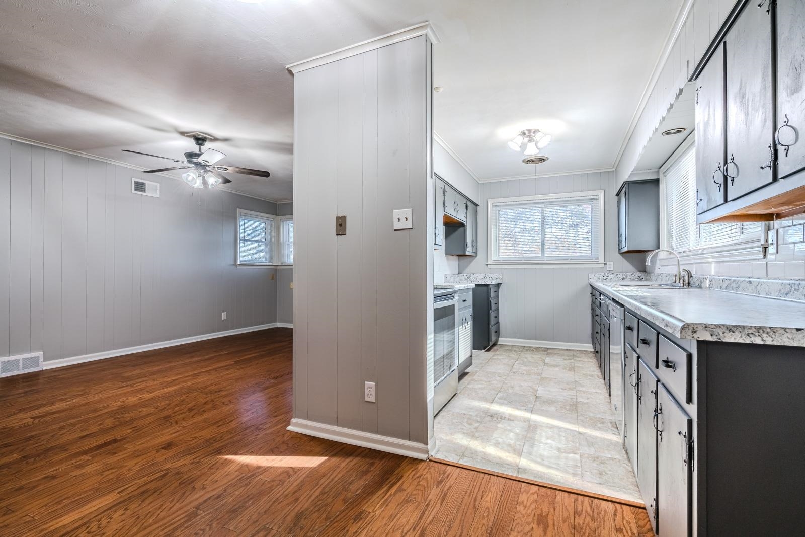 4202 Ambrose Road Memphis, TN 38116 - Photo 16 of 28 a view of a kitchen with a sink and dishwasher with wooden floor