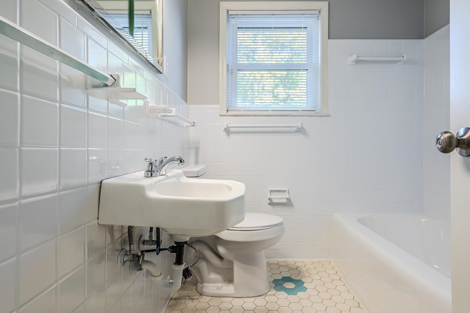 4202 Ambrose Road Memphis, TN 38116 - Photo 17 of 28 a bathroom with a sink a toilet and bathtub