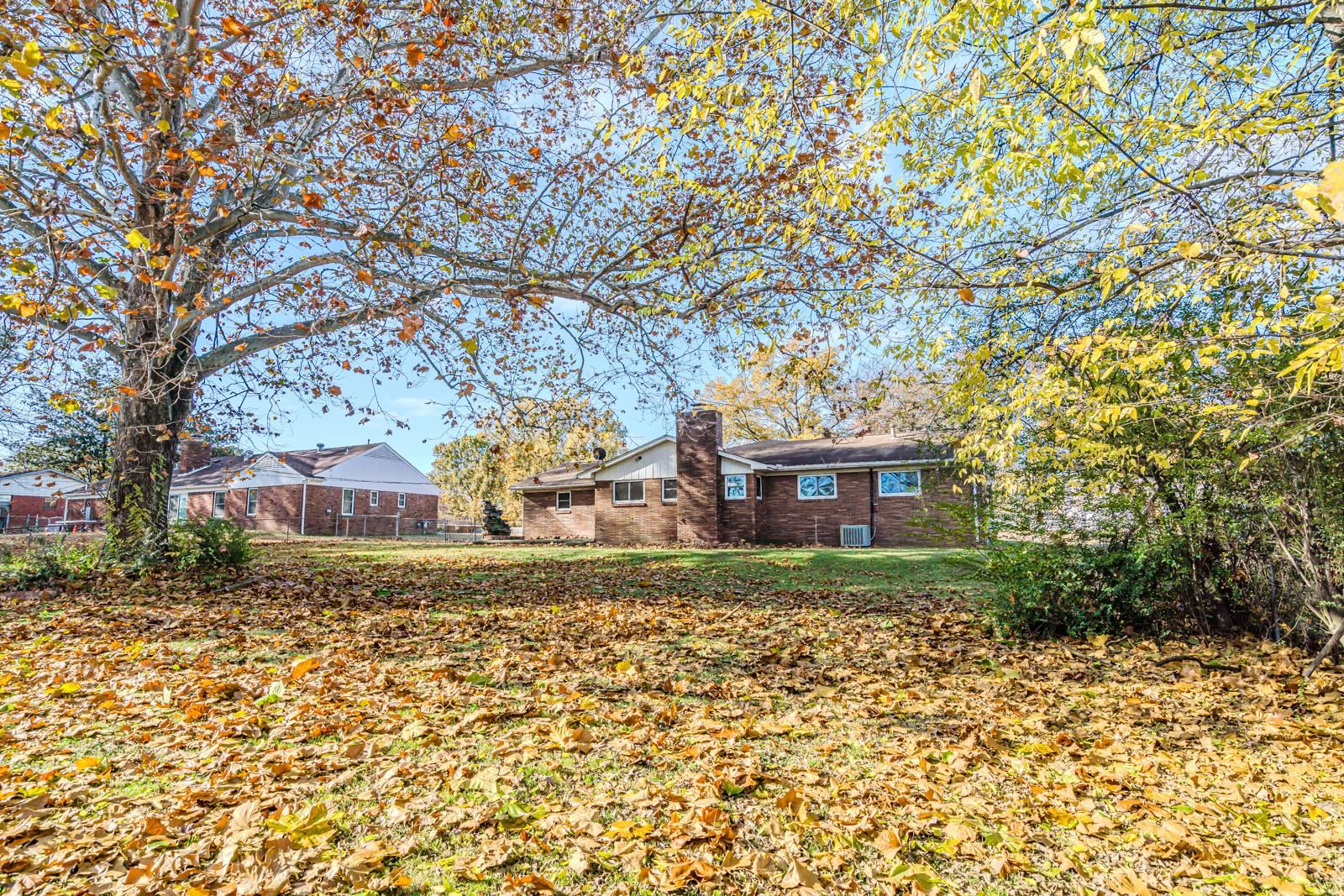 4202 Ambrose Road Memphis, TN 38116 - Photo 27 of 28 a view of a yard in front of a house with large trees