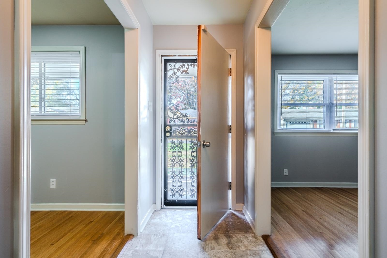 4202 Ambrose Road Memphis, TN 38116 - Photo 6 of 28 a view of an empty room with wooden floor and a window