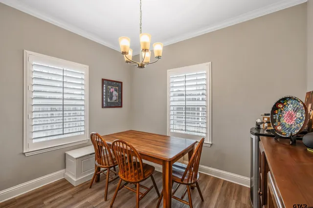 a view of a dining room with furniture wooden floor and chandelier