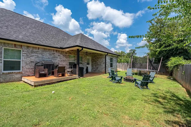 a view of a house with backyard porch and sitting area