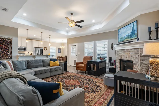 a living room with furniture fireplace and a window