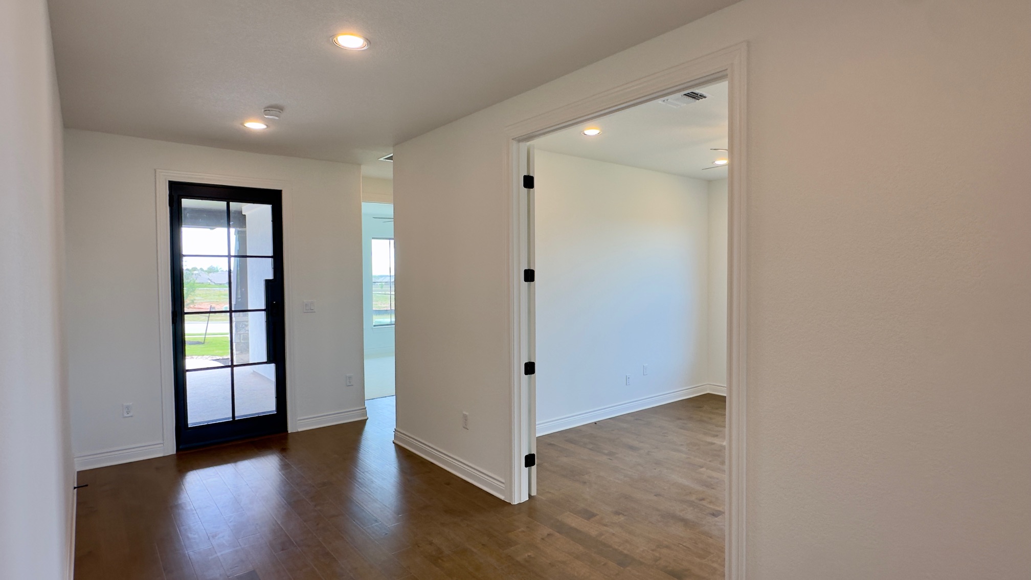 150 Firethorn Loop Bastrop, TX 78602 - Photo 12 of 39 an empty room with wooden floor and windows