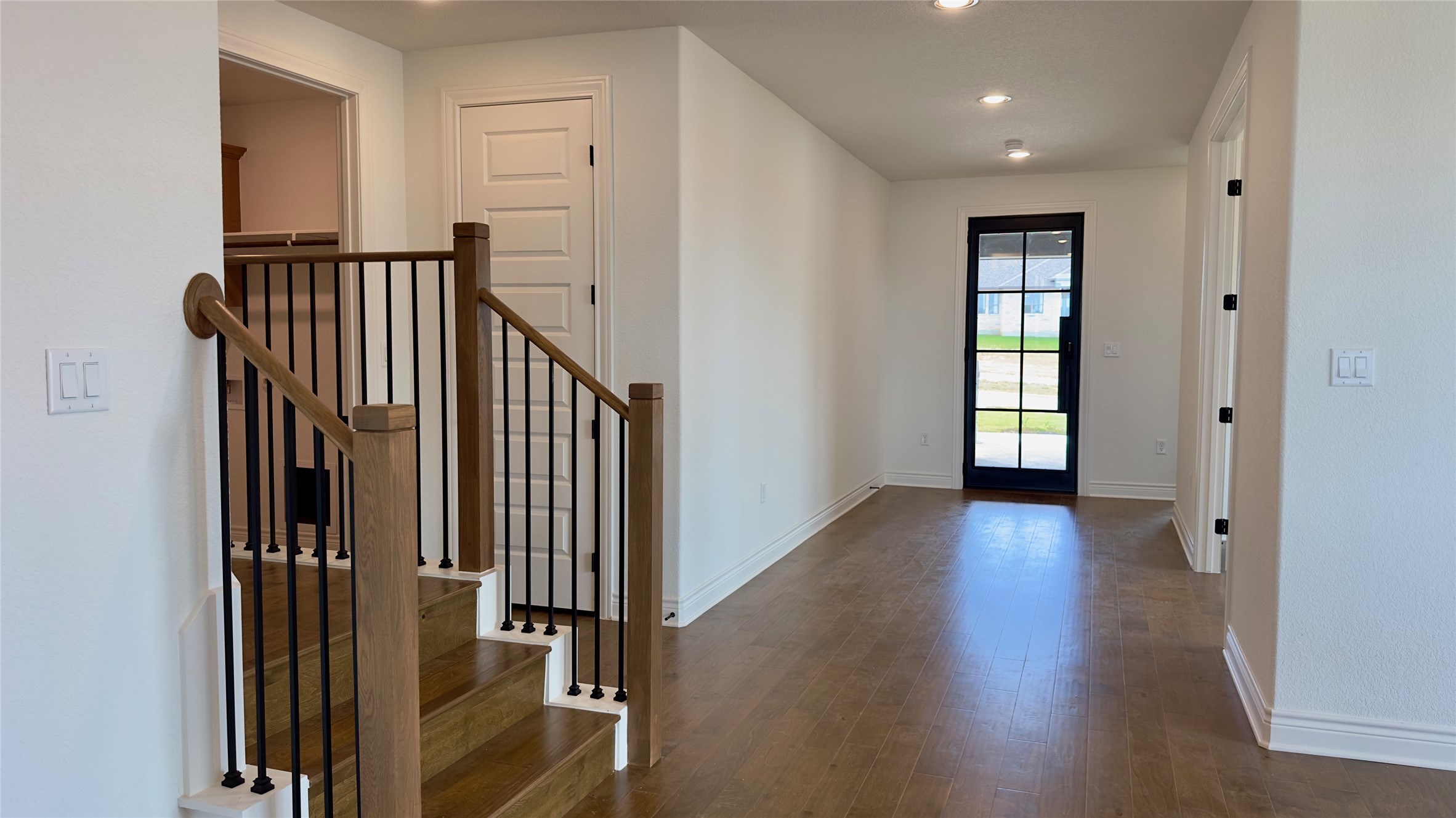 150 Firethorn Loop Bastrop, TX 78602 - Photo 14 of 39 a view of hallway with stairs and wooden floor