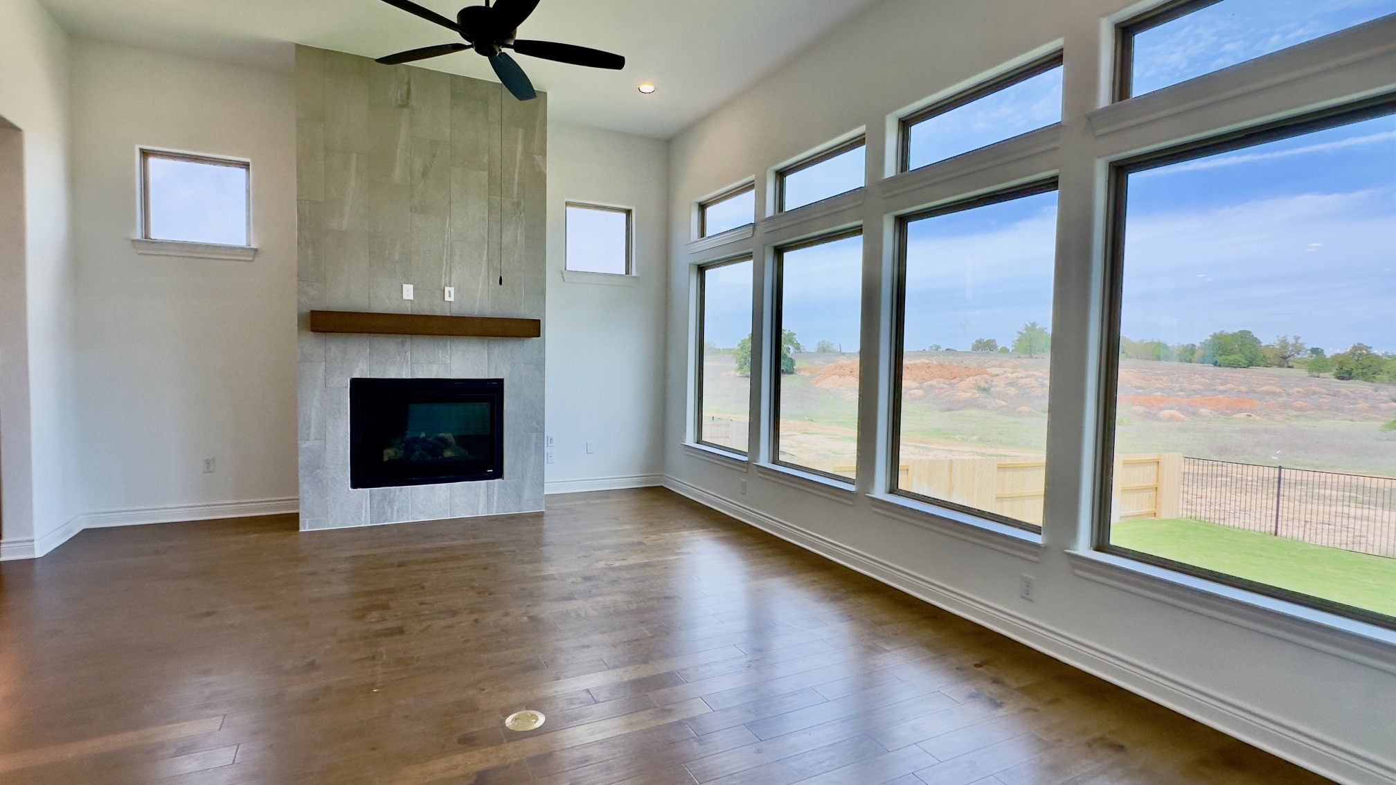 150 Firethorn Loop Bastrop, TX 78602 - Photo 20 of 39 a view of an empty room with wooden floor and a window