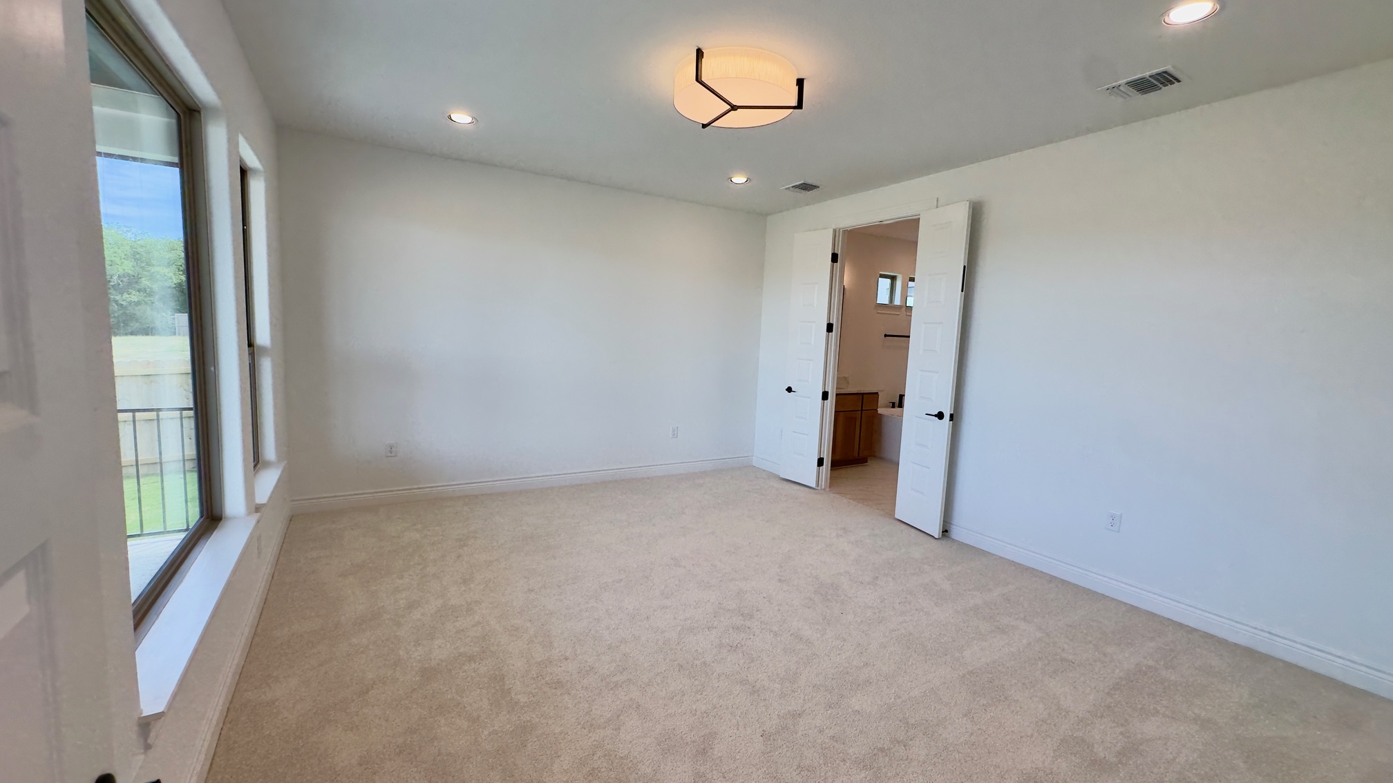 150 Firethorn Loop Bastrop, TX 78602 - Photo 21 of 39 an empty room with an entryway and a window