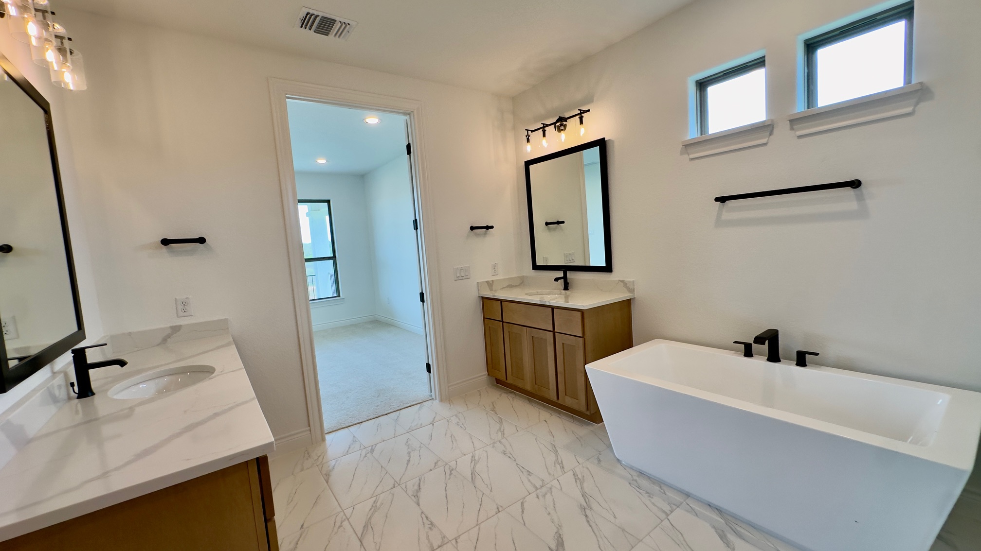 150 Firethorn Loop Bastrop, TX 78602 - Photo 24 of 39 a bathroom with a tub sink and mirror