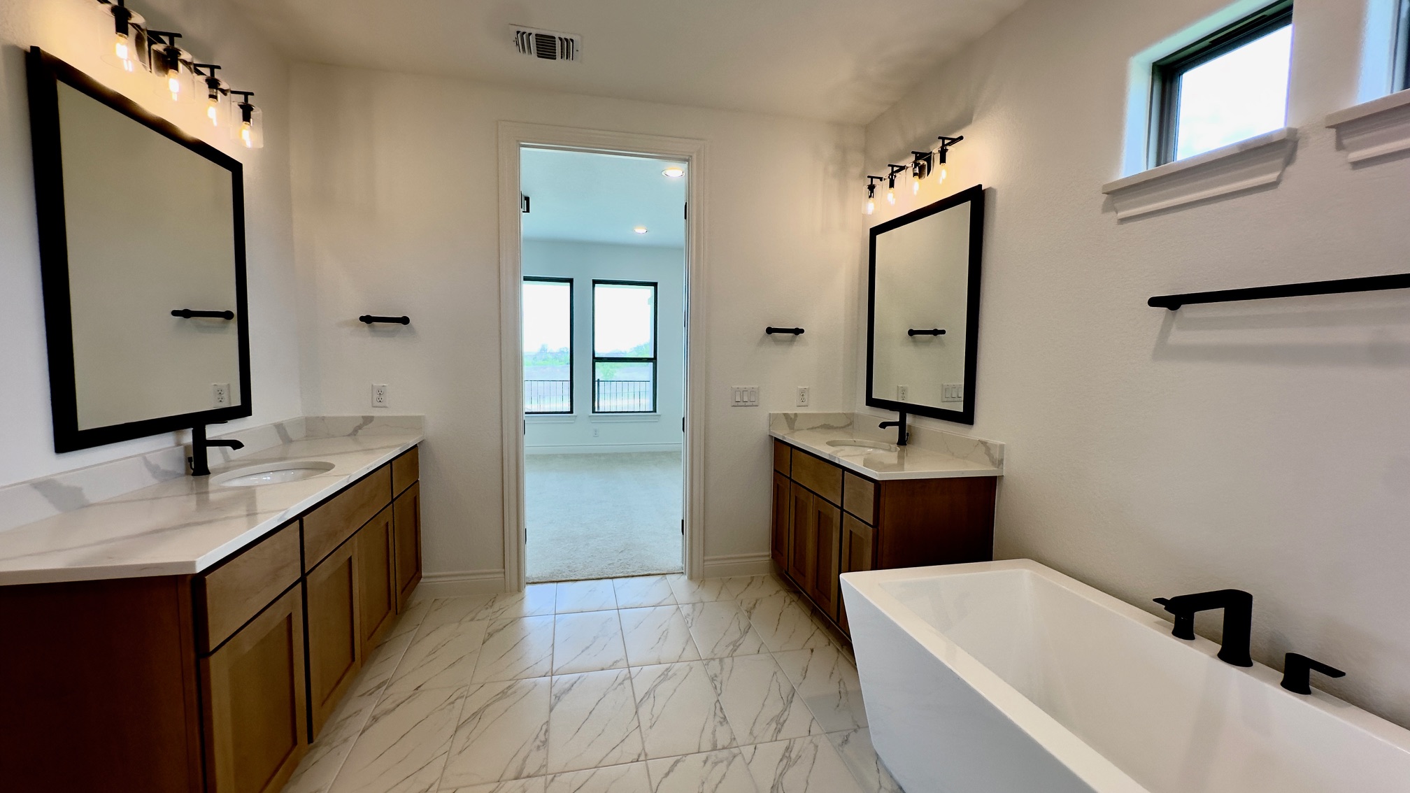 150 Firethorn Loop Bastrop, TX 78602 - Photo 27 of 39 a bathroom with a tub sink and mirror