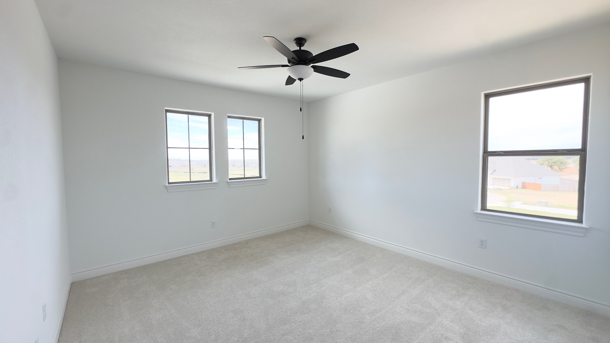 150 Firethorn Loop Bastrop, TX 78602 - Photo 31 of 39 an empty room with windows and ceiling fan