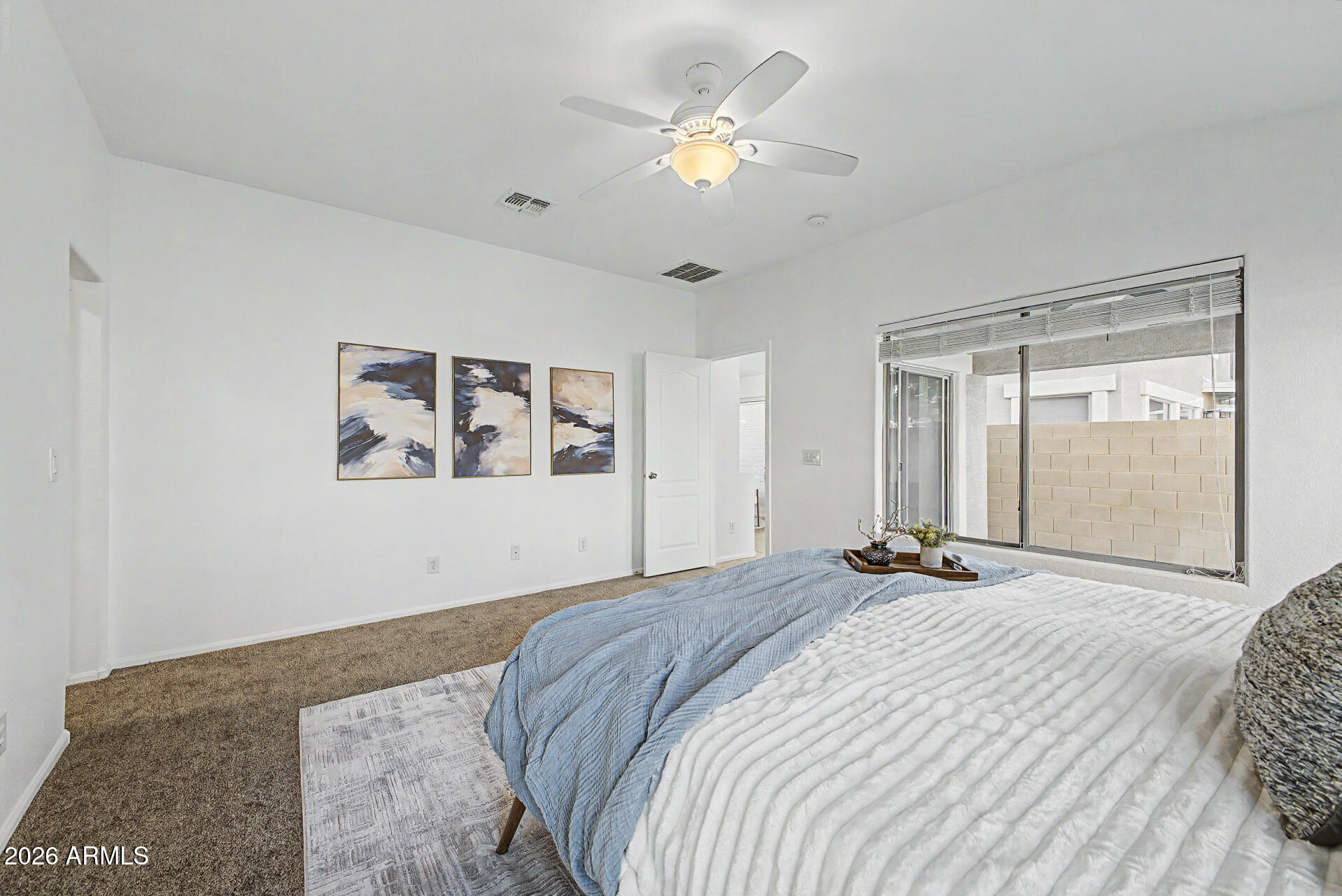 4168 East Sandy Way Gilbert, AZ 85297 - Photo 16 of 47 a bedroom with a large bed and a chandelier