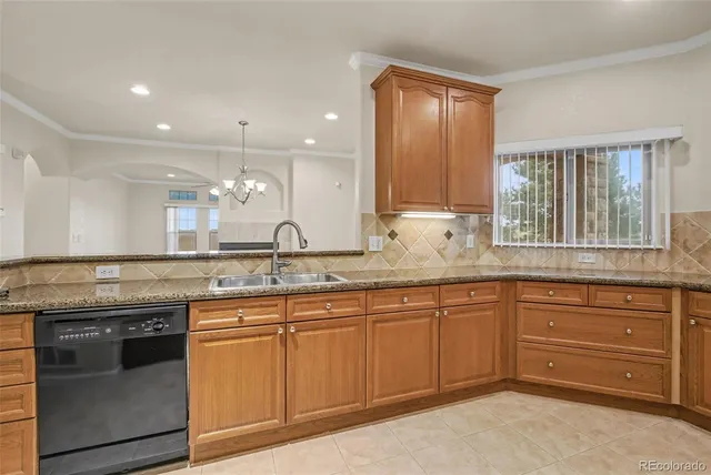a kitchen with stainless steel appliances granite countertop a sink and a stove