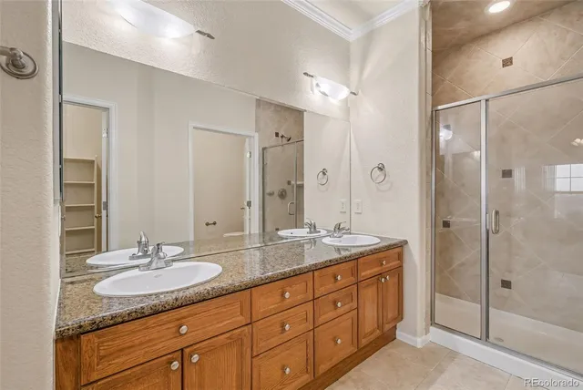 an empty room with a chandelier fan and windows