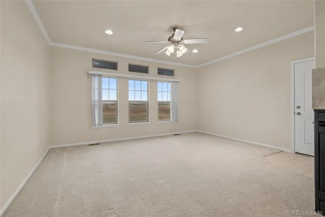 a view of a kitchen with a refrigerator and a window