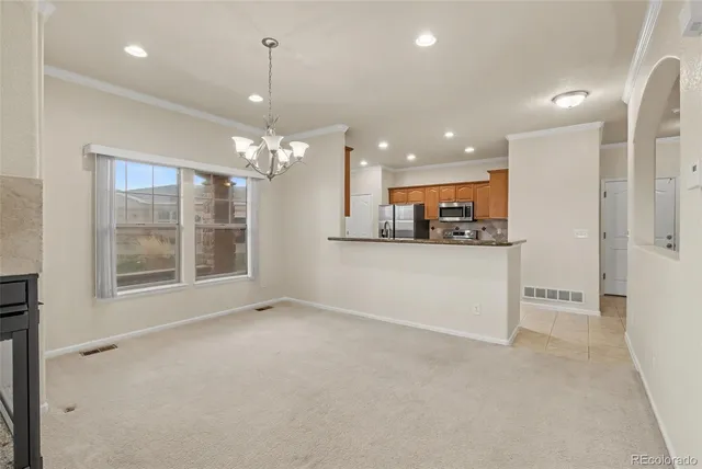 a large kitchen with kitchen island granite countertop a sink stove and refrigerator